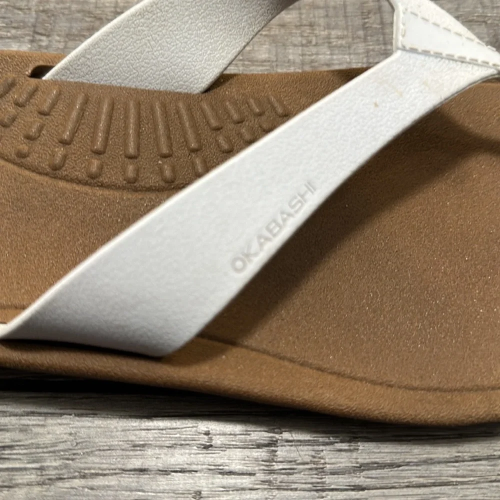 Okabashi flip flops with white straps and neutral color bottoms